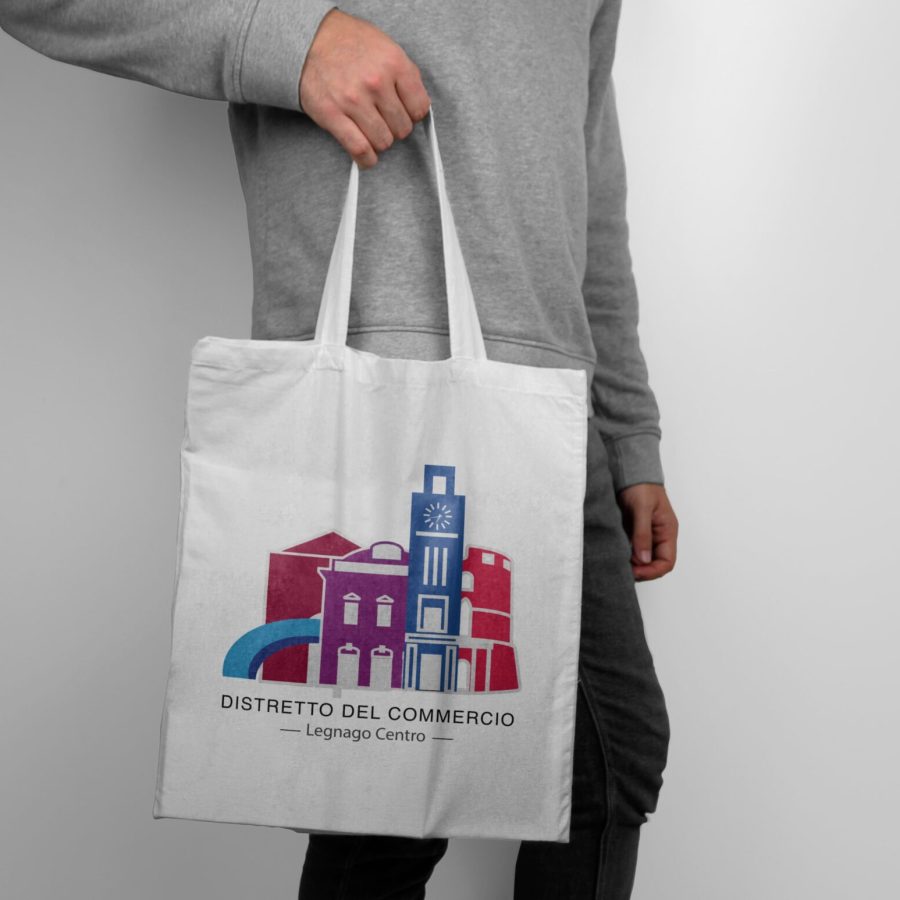 Mockup_of_model_holding_a_white_tote_bag-min